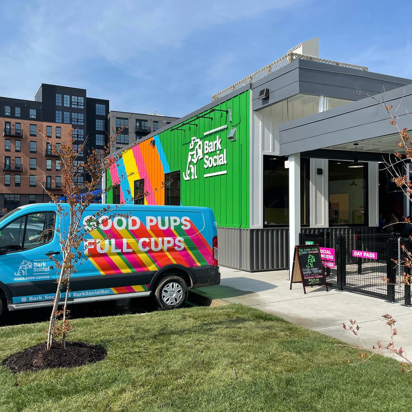 Exterior of Bark Social with their van that says: good pups full cups