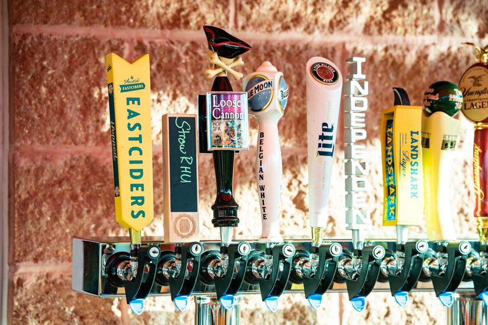 a row of beer taps