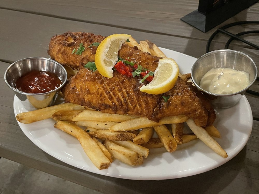 a plate of fish and chips on a table