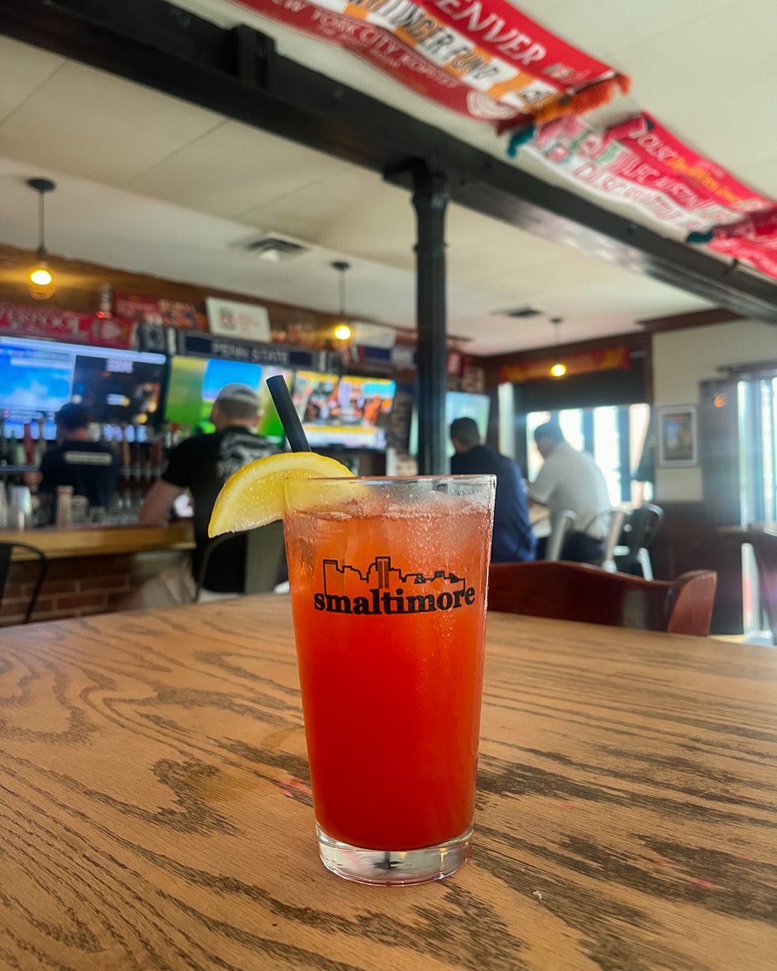 a red mixed drink on a table