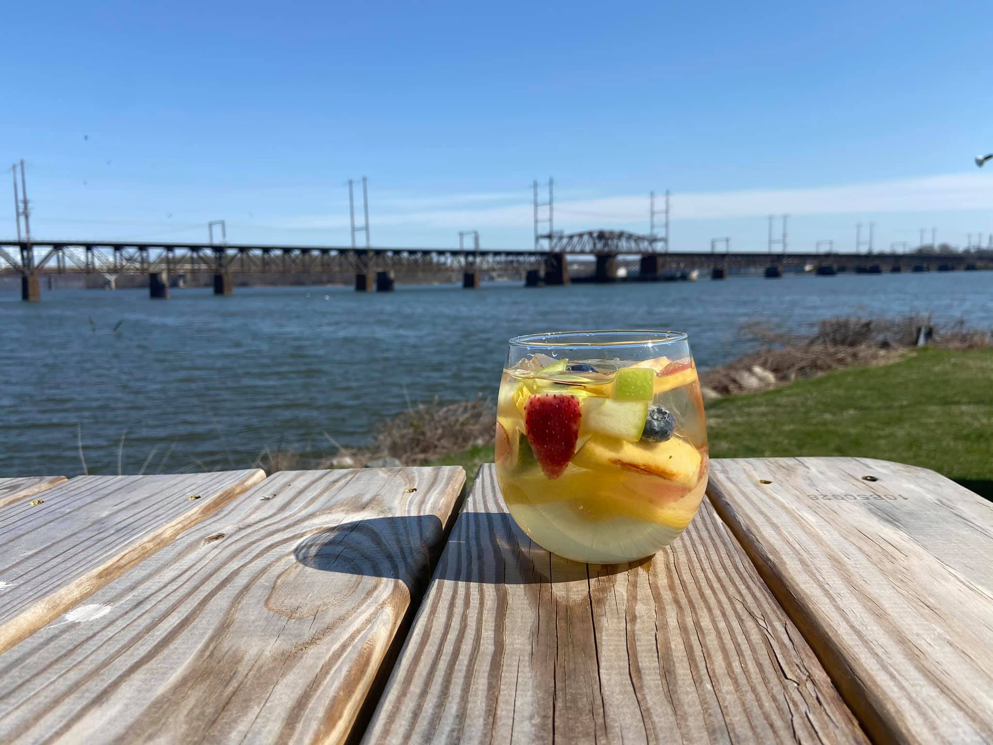 Fruity drink on table outside looking over the water