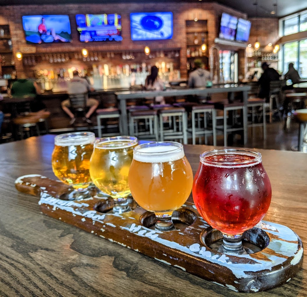 a Flight of Beers on a table facing the bar