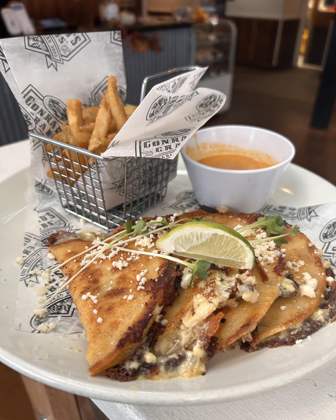 Lobster birria tacos with a basket of fries