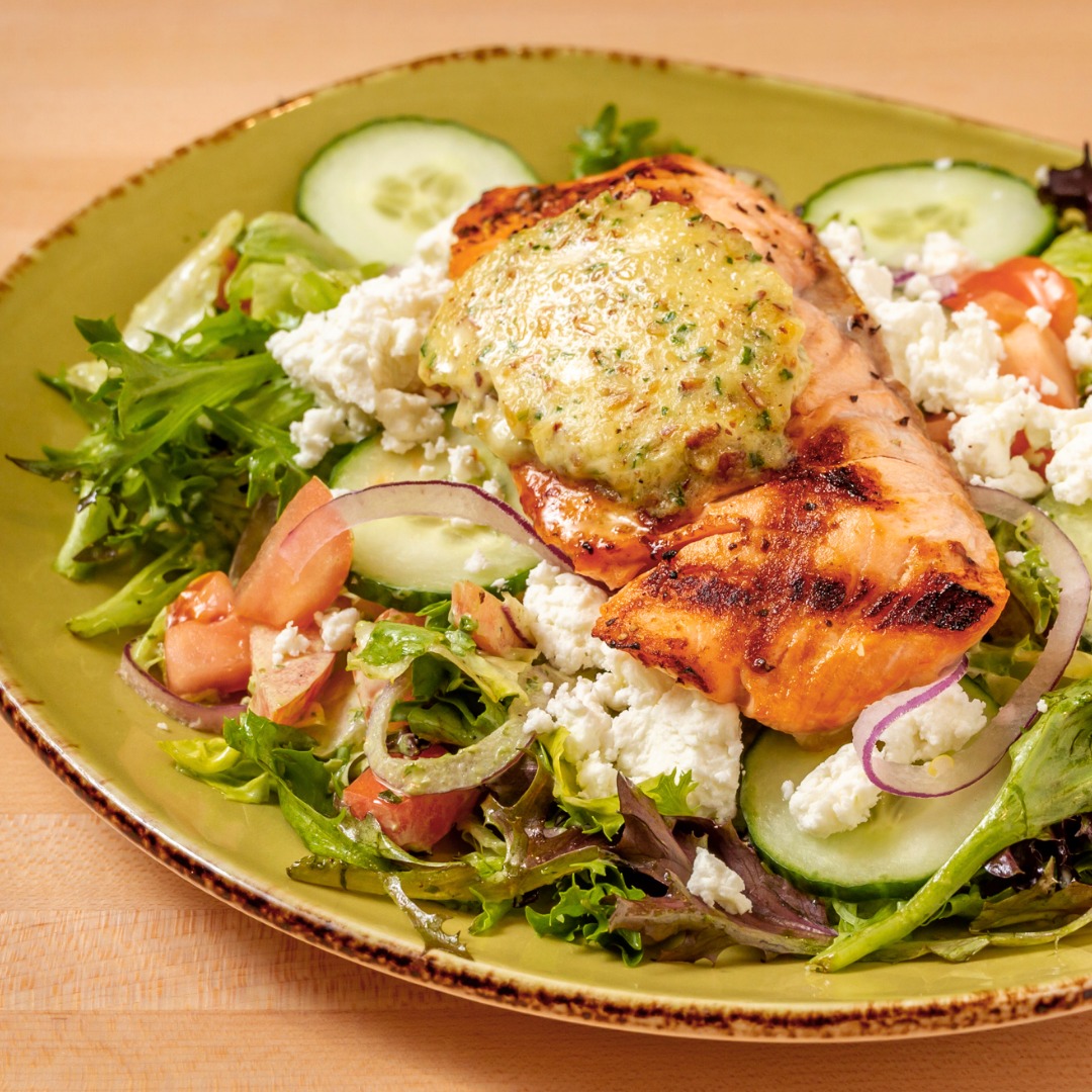 a plate of grilled salmon salad