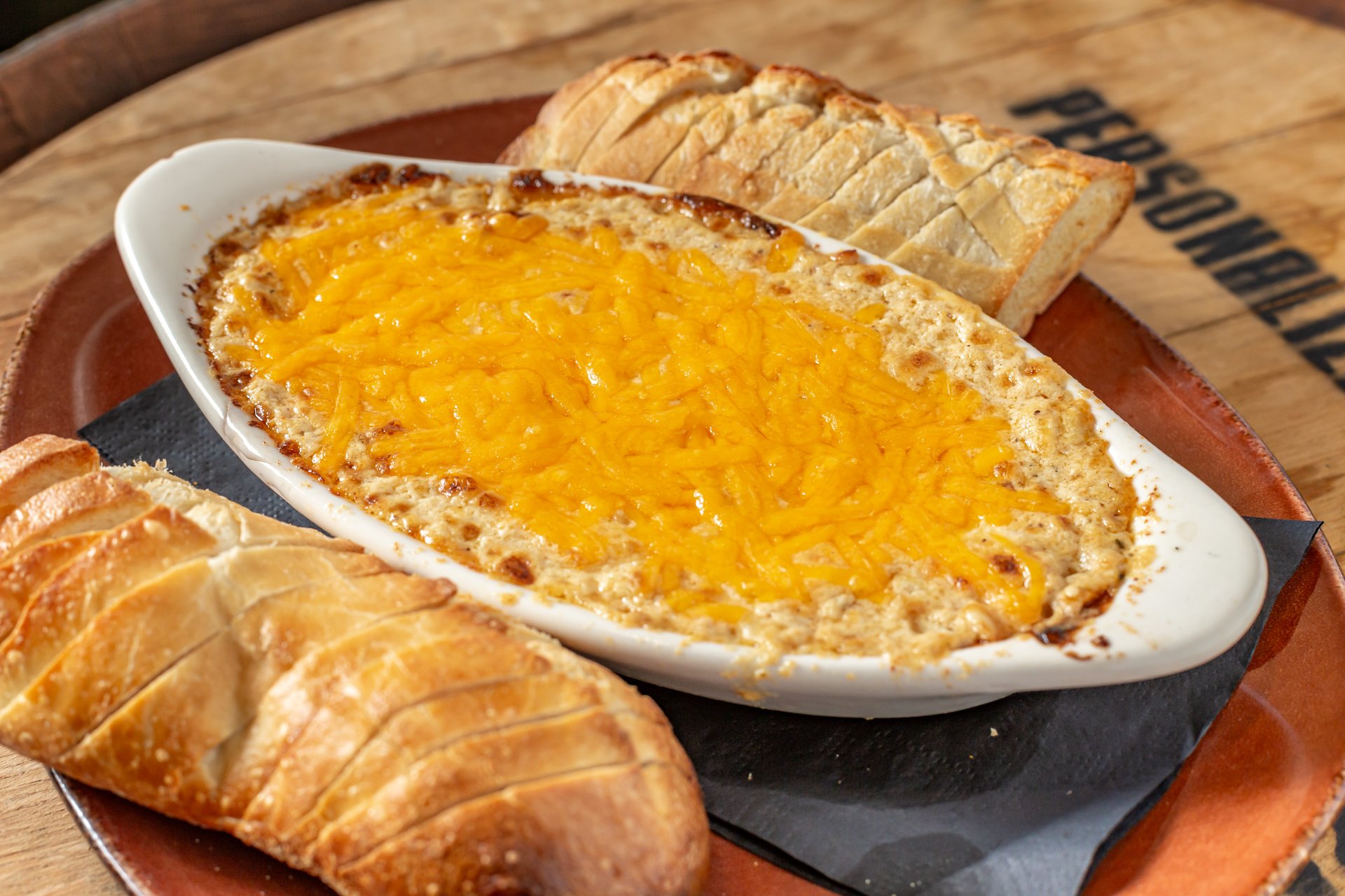 a bowl of baked crab dip with bread