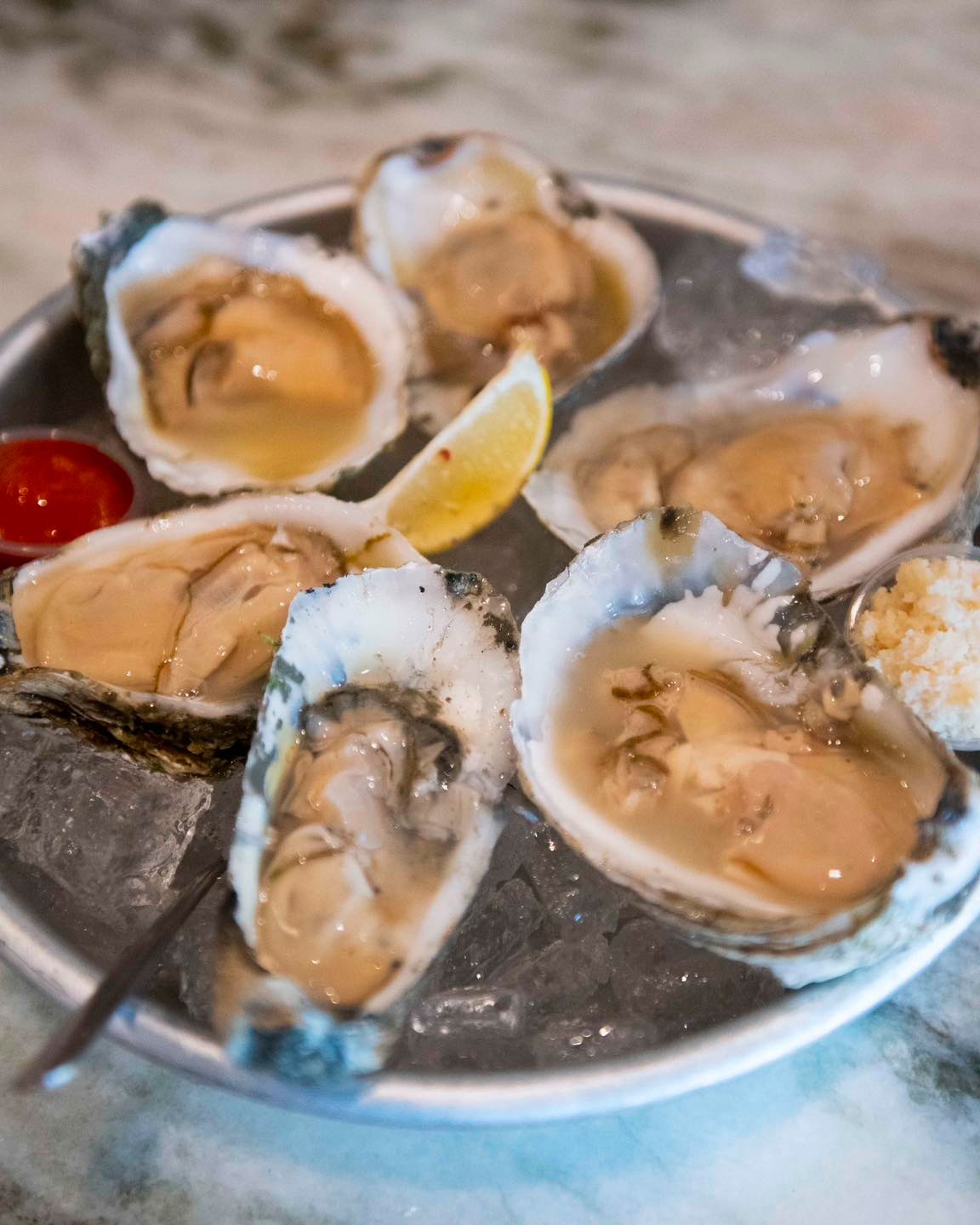 oysters on ice and a lemon wedge