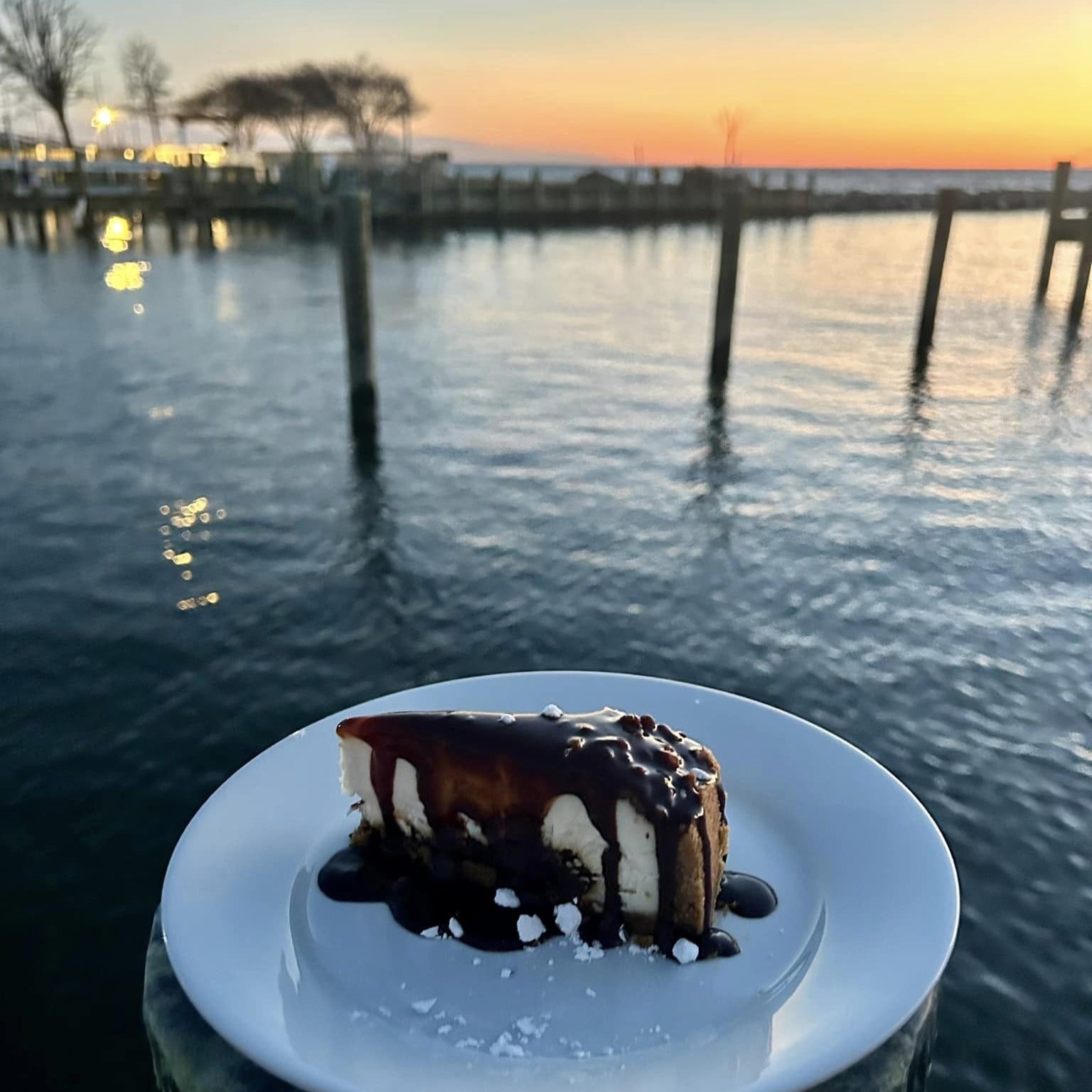 a slice of Guinness Cheesecake overlooking the water