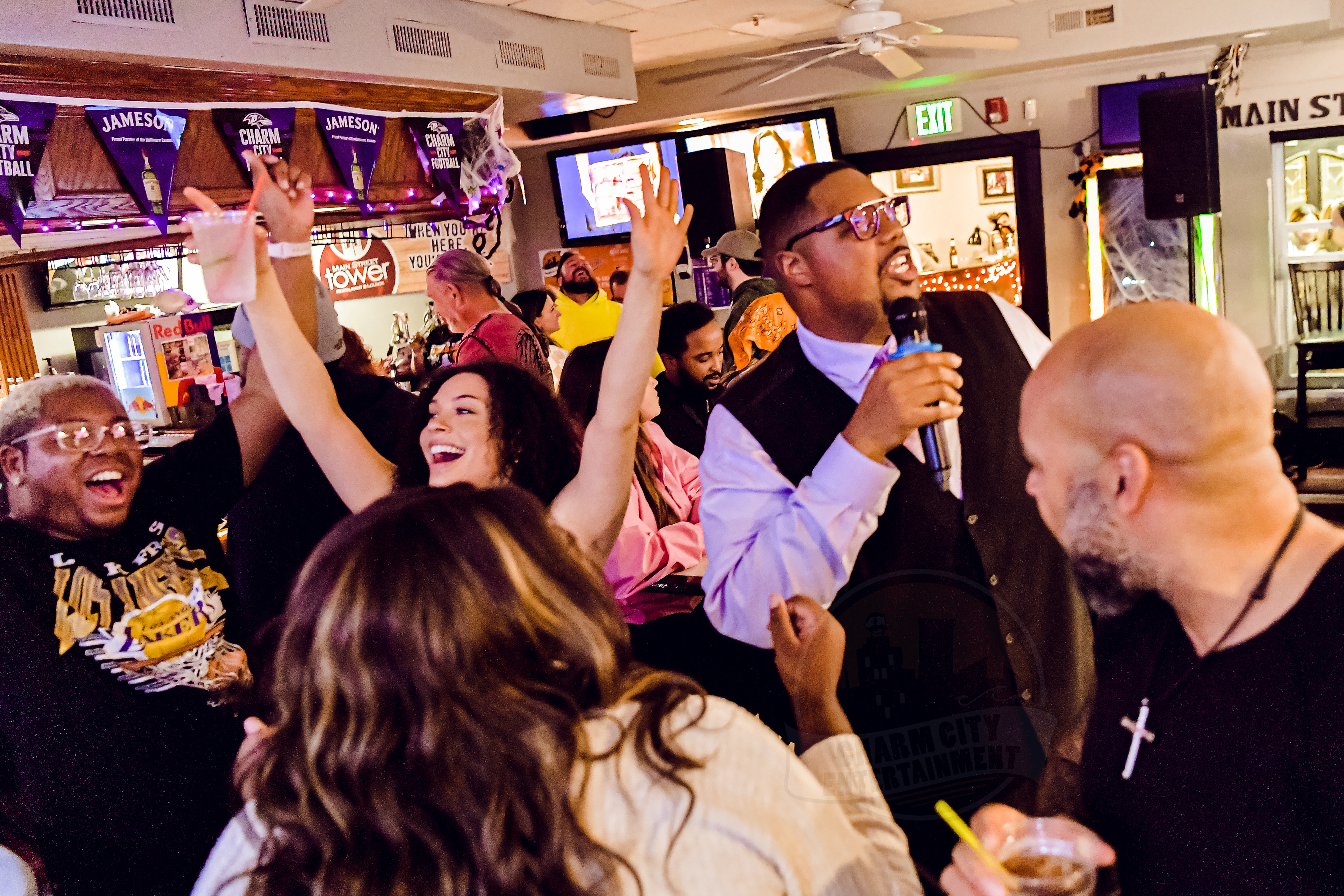 a person singing with a group of people dancing