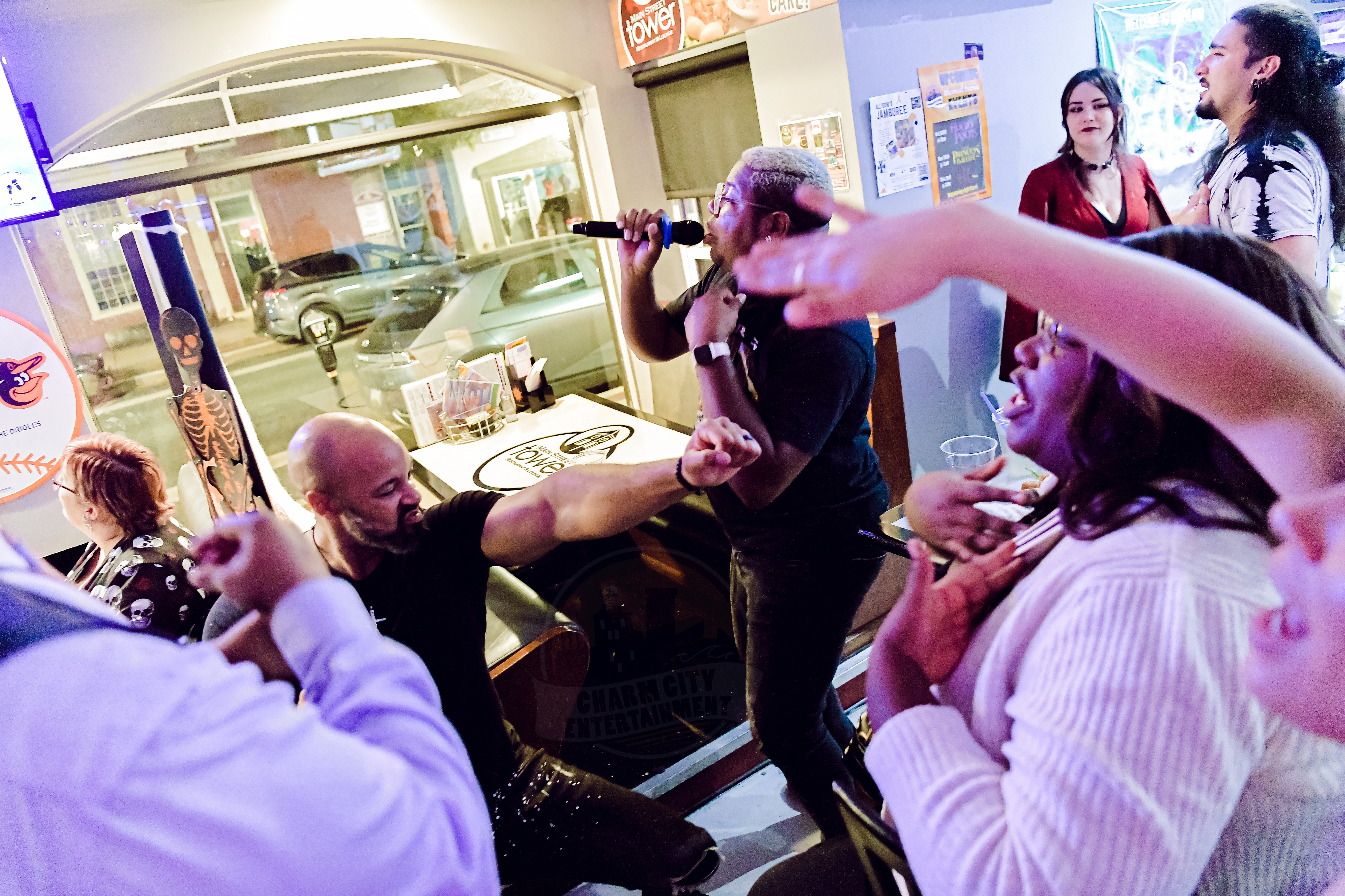 a person singing with a group of people dancing