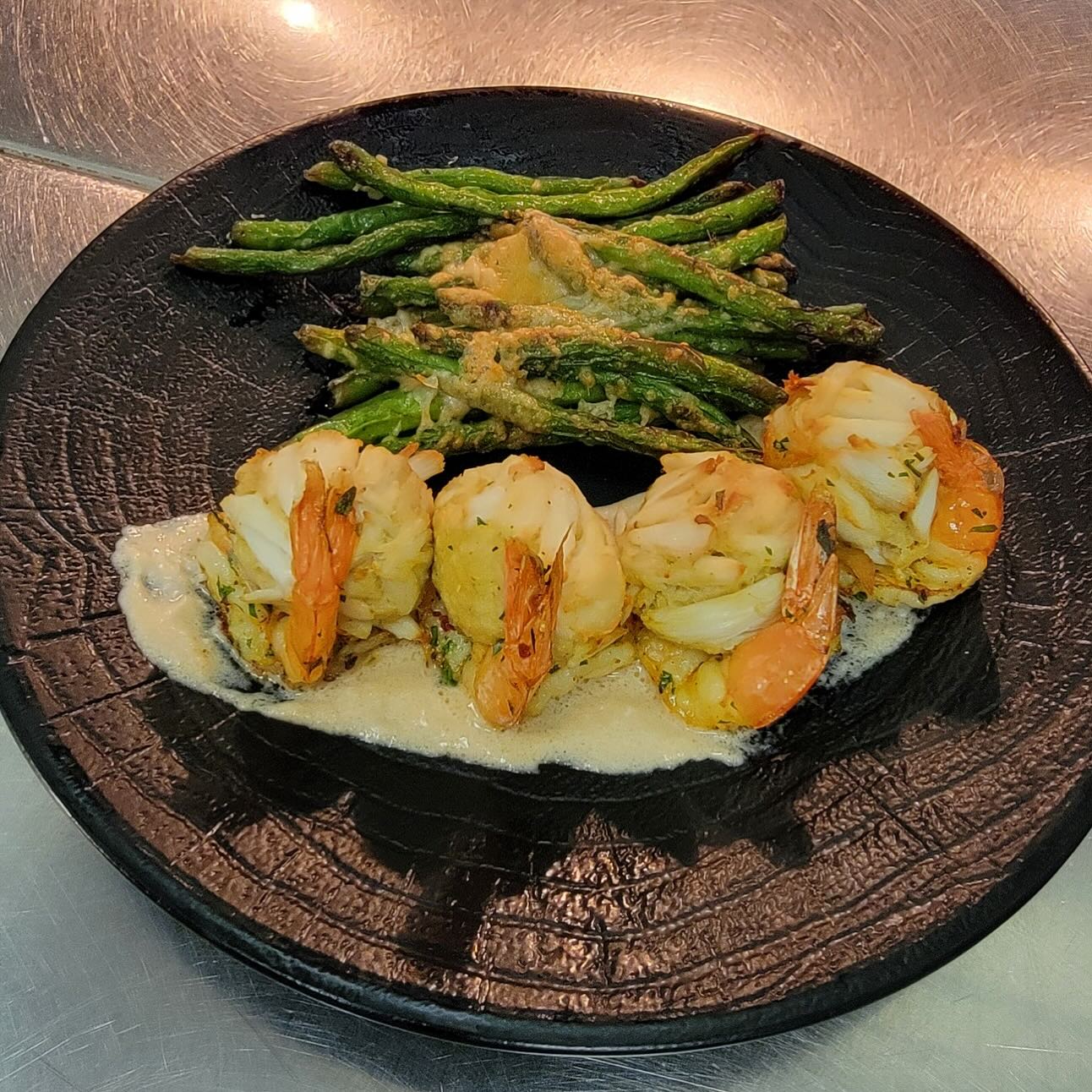 crab stuffed shrimp with coconut sherry sauce and parmesan green beans