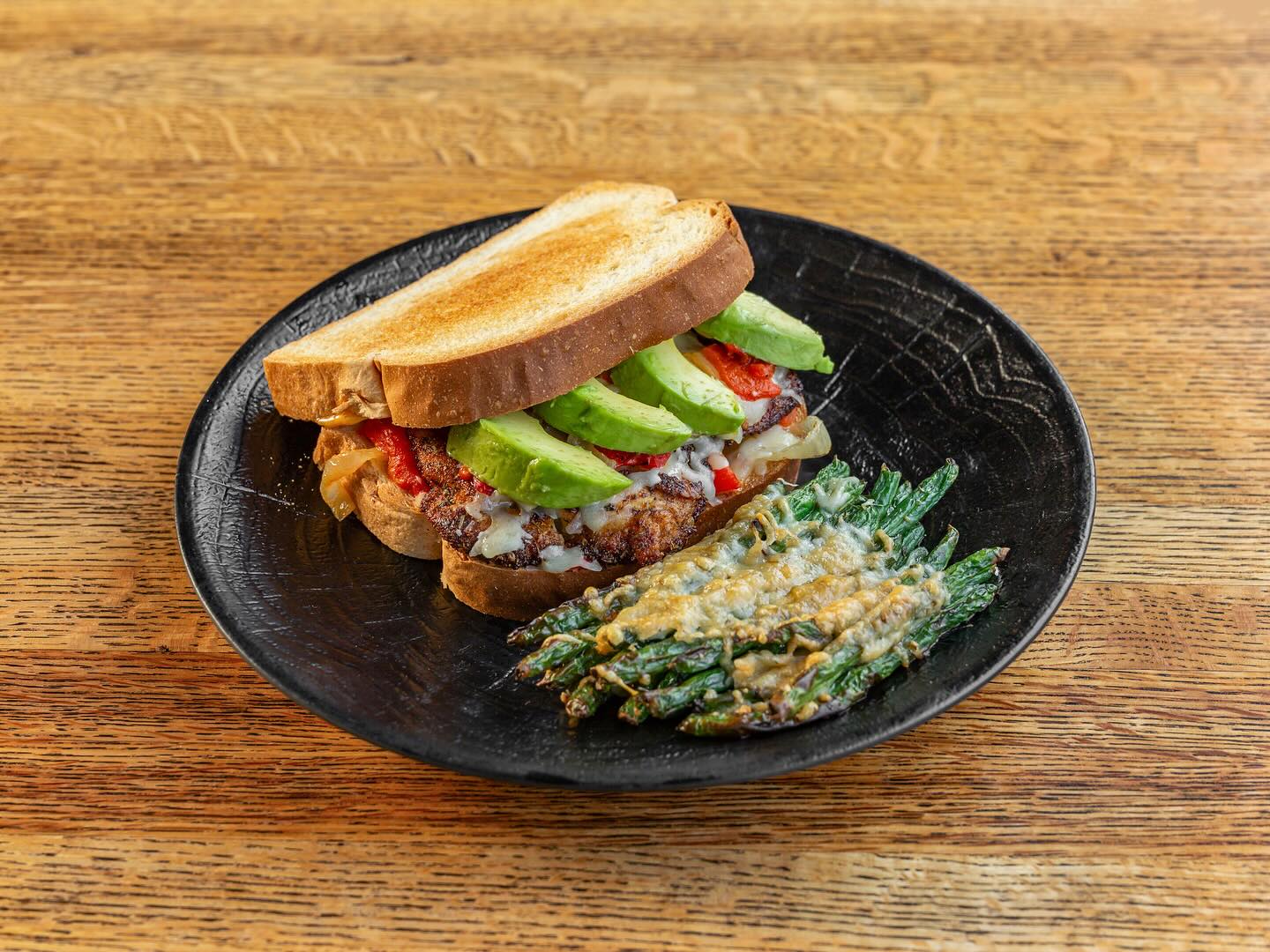 a blackened chicken sandwich with parmesan green beans