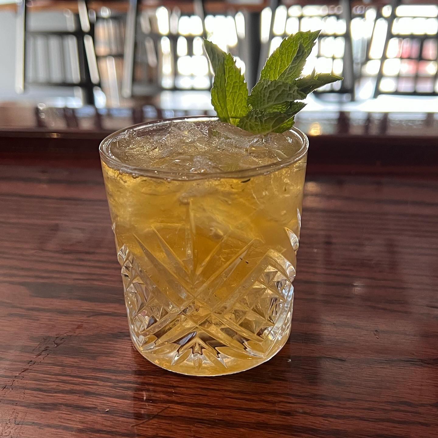 a mint julep with a sprig of mint