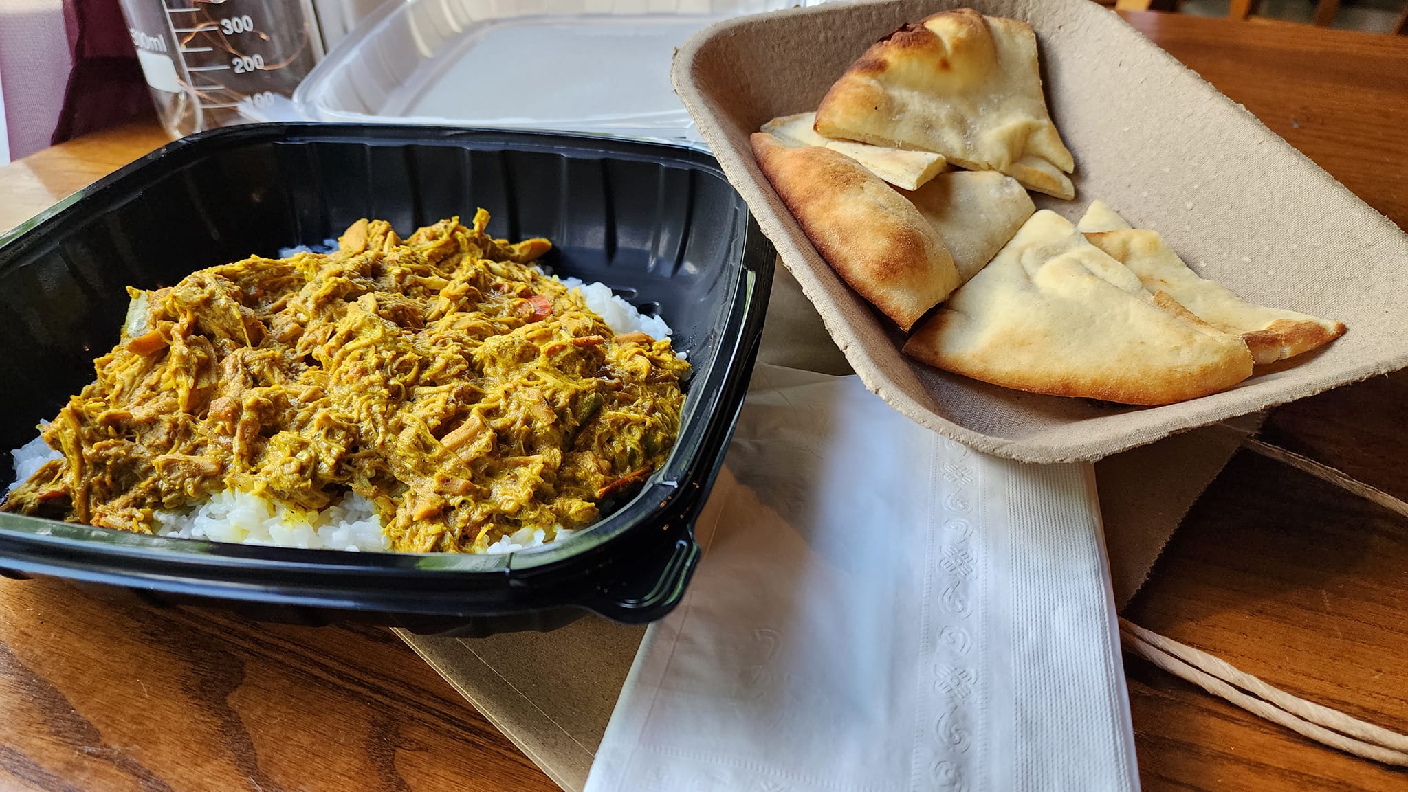 a Curry Chicken entrée with naan bread