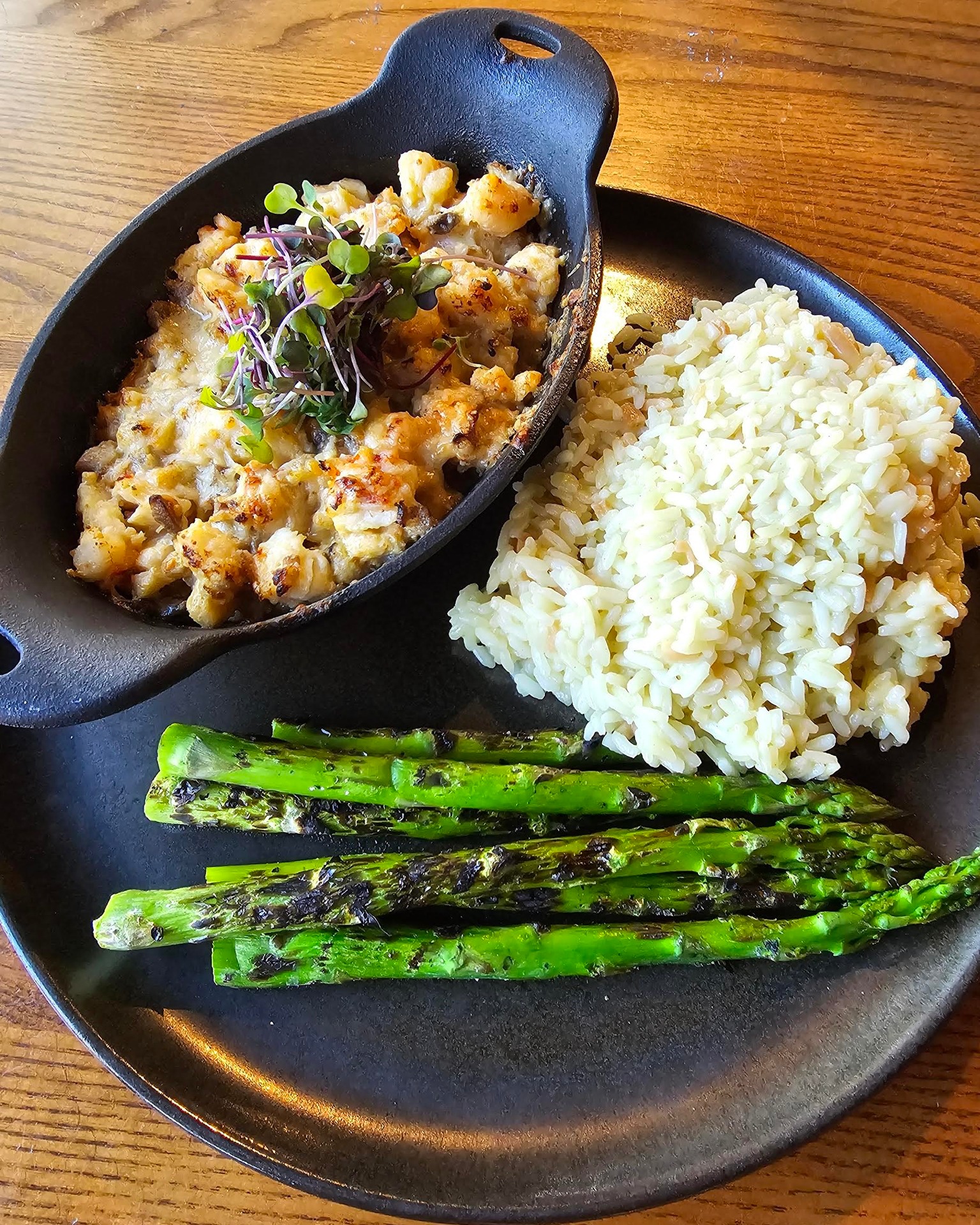 a lobster thermidor with rice and asparagus