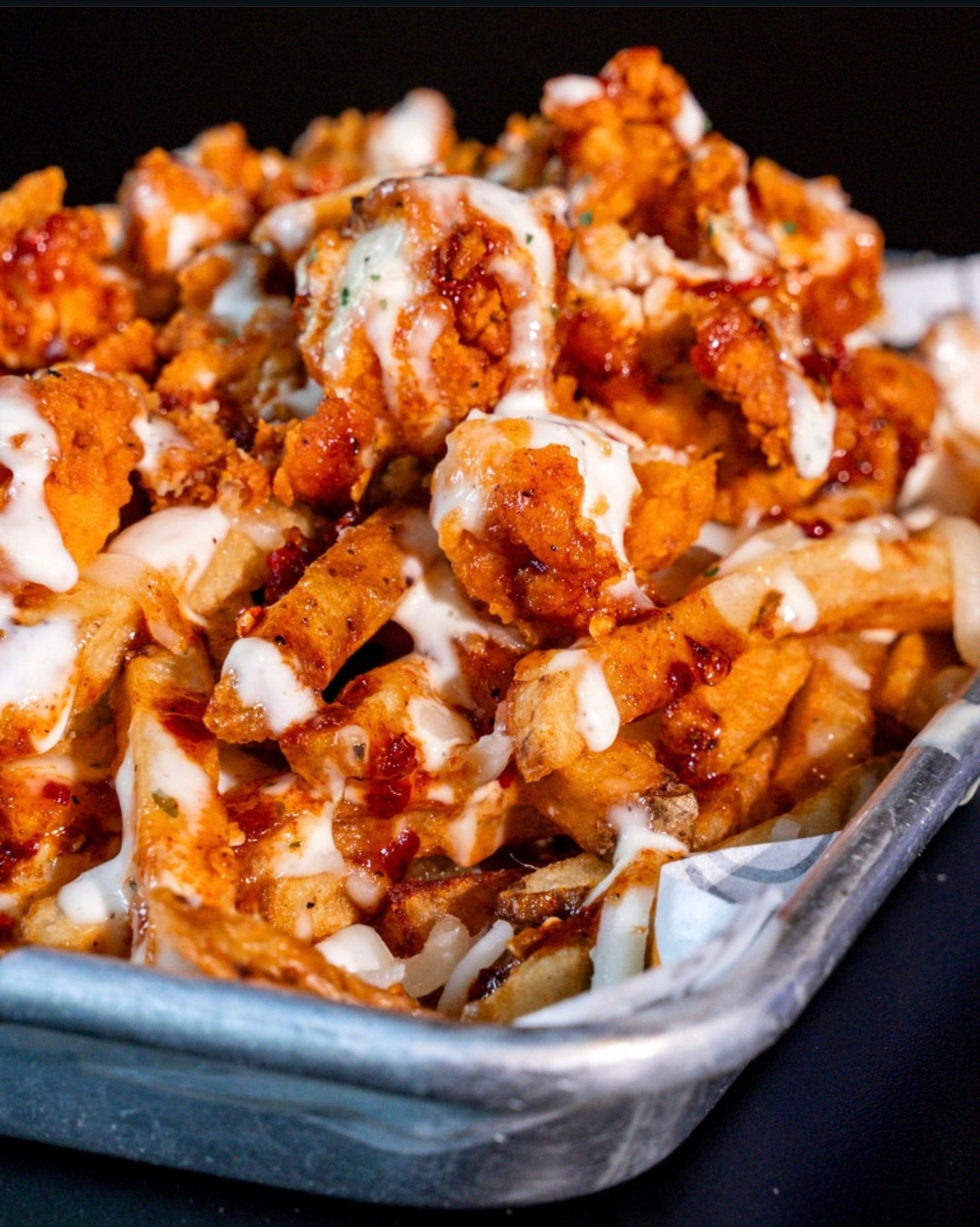 a platter of loaded fries from Just Chicken