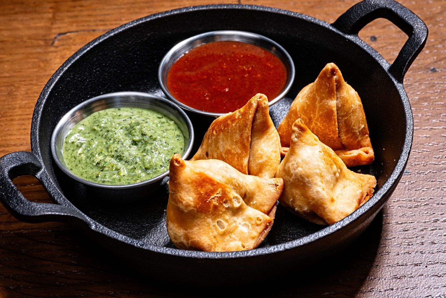 a plate of vegetable samosa bites with dips from Kati Roll Wala