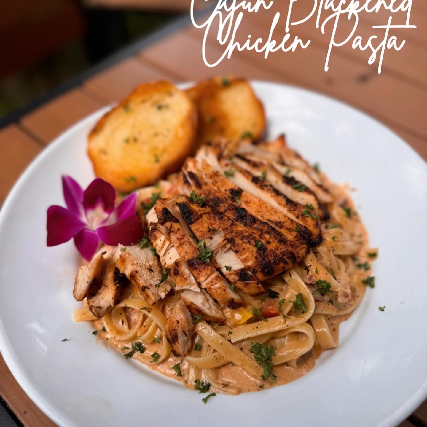 a plate of cajun blackened chicken pasta