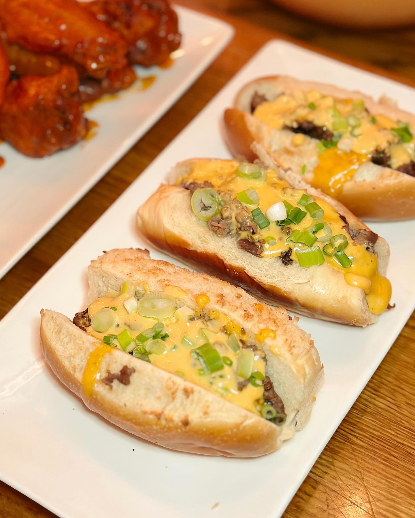 three cheesesteak sliders on a plate