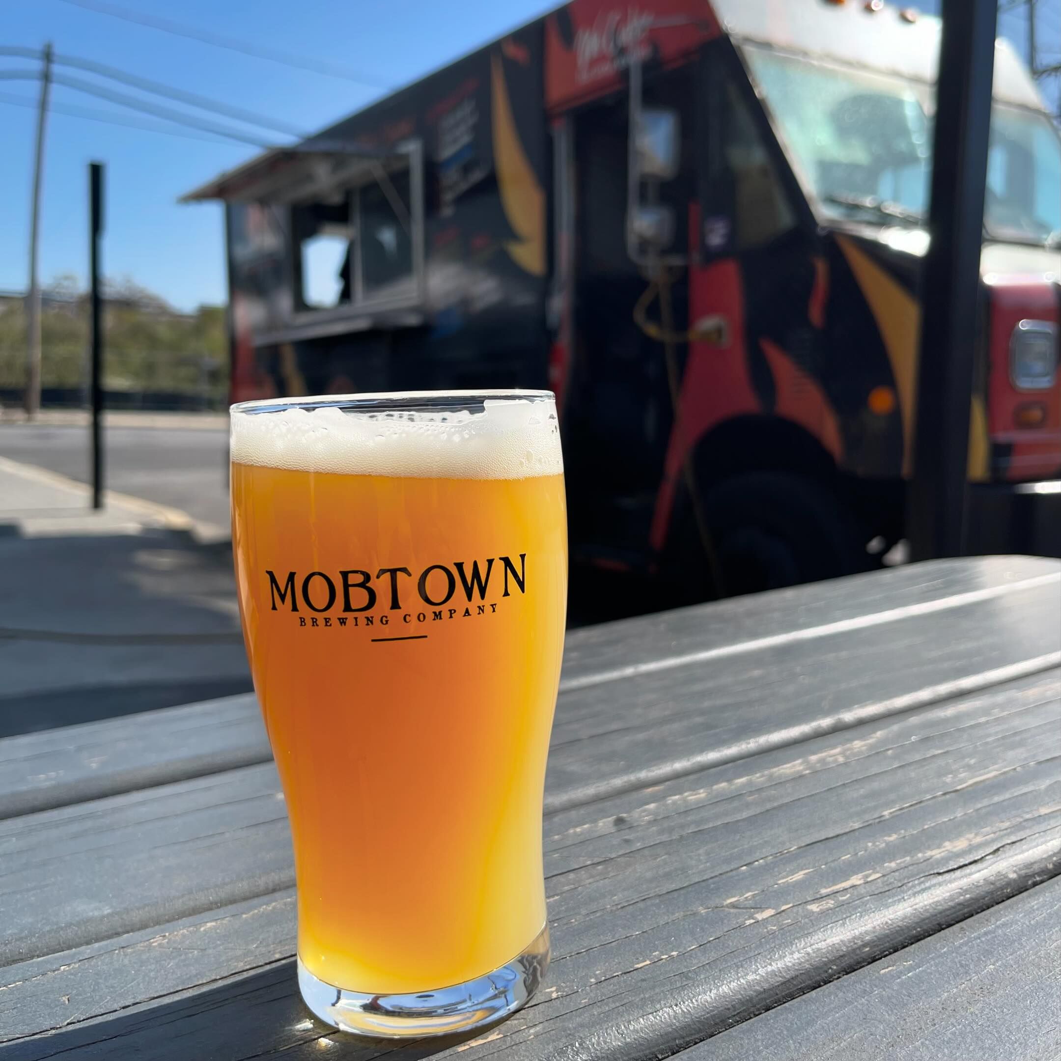 a glass of beer outside on a table