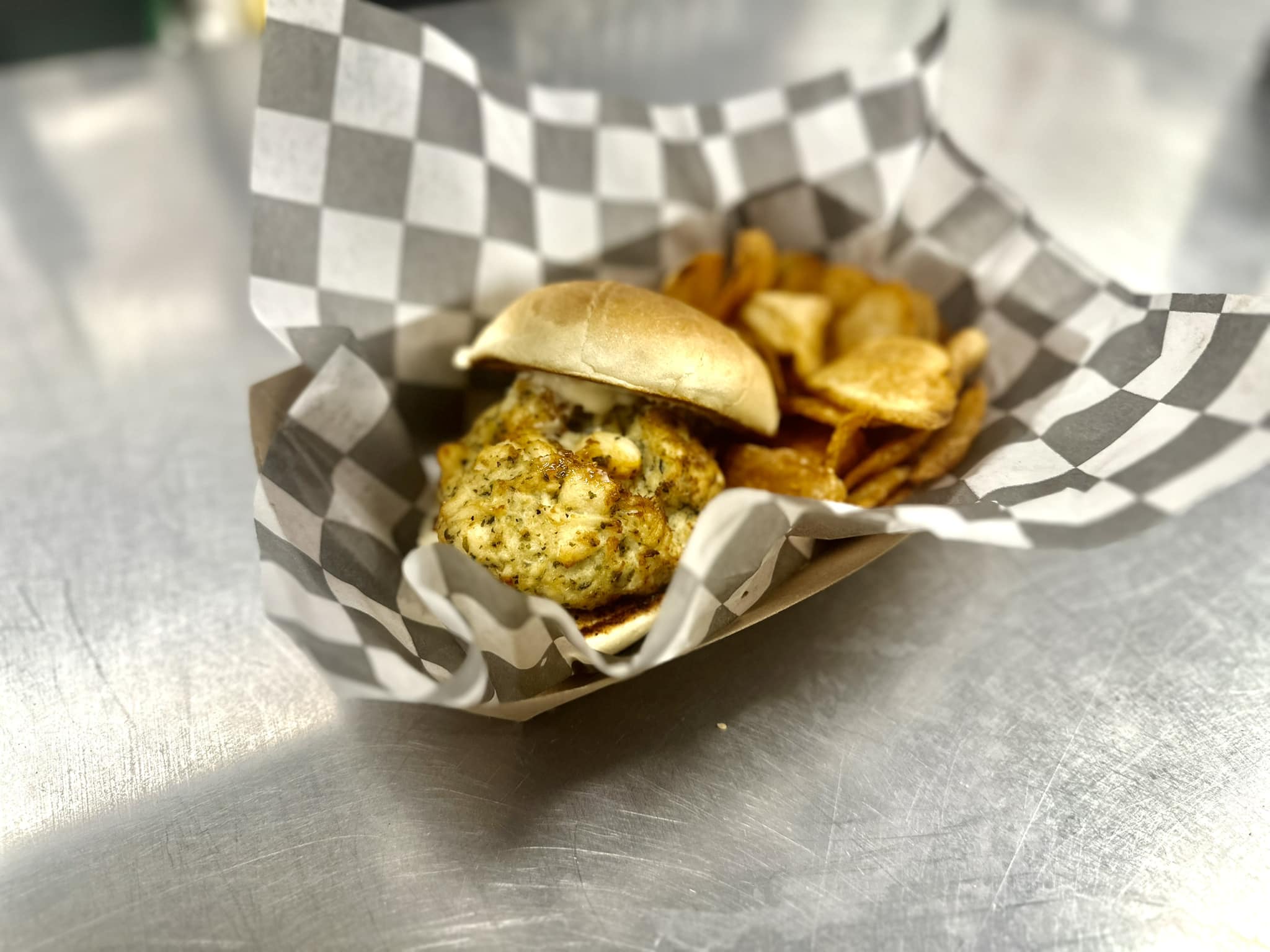 a crab cake sandwich with old bay potato chips