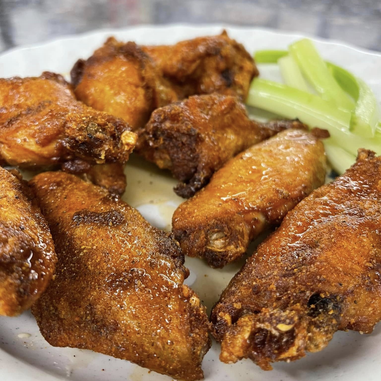 a plate of wings with celery