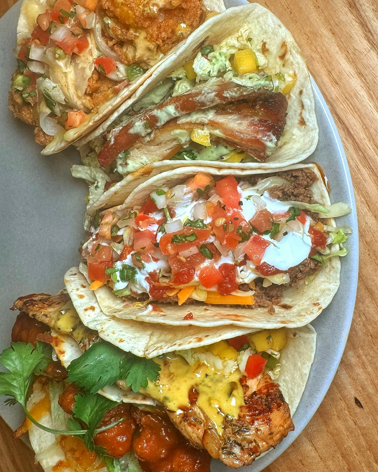 a plate full of several tacos