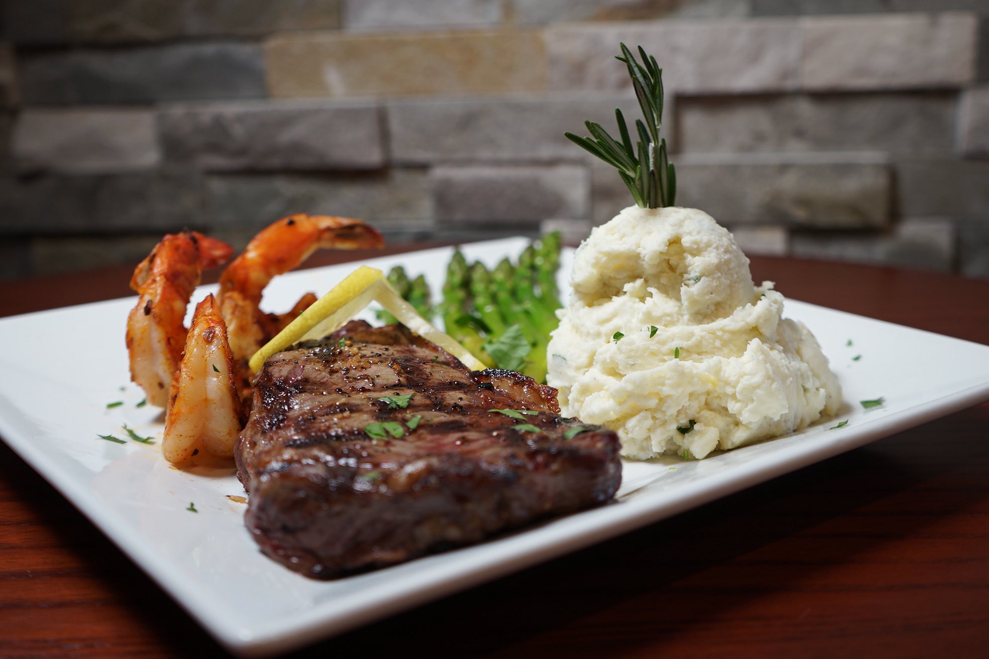 steak with mashed potatoes, asparagus, and shrimp