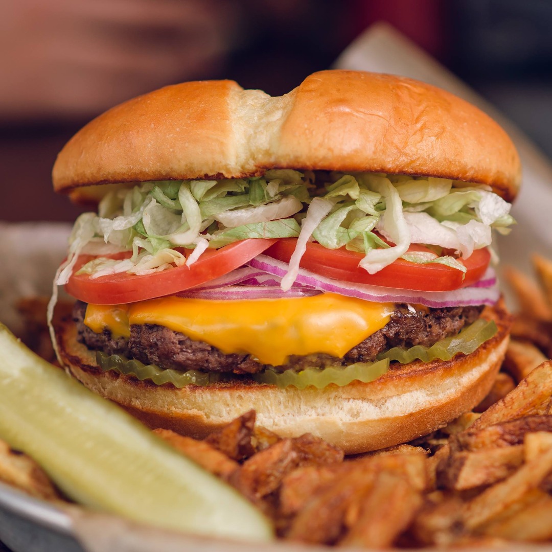 a burger with fries and a pickle