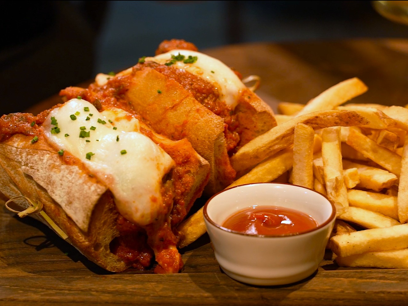 a meatball sandwich with fries