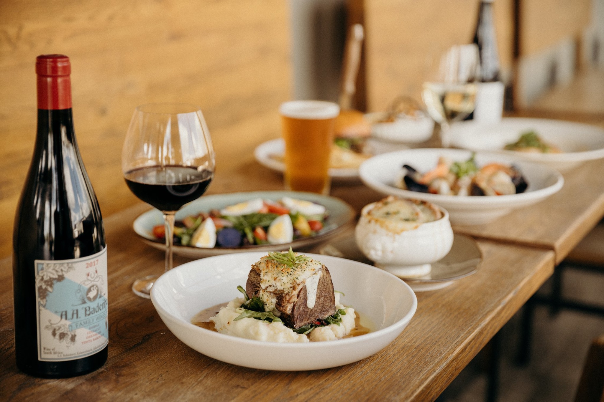 several plates of food and glasses of drinks