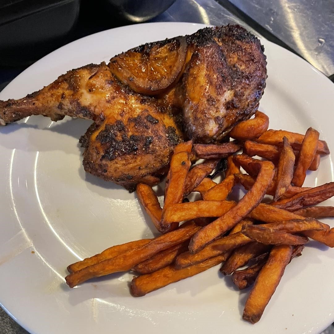 a plate of chicken legs with fries