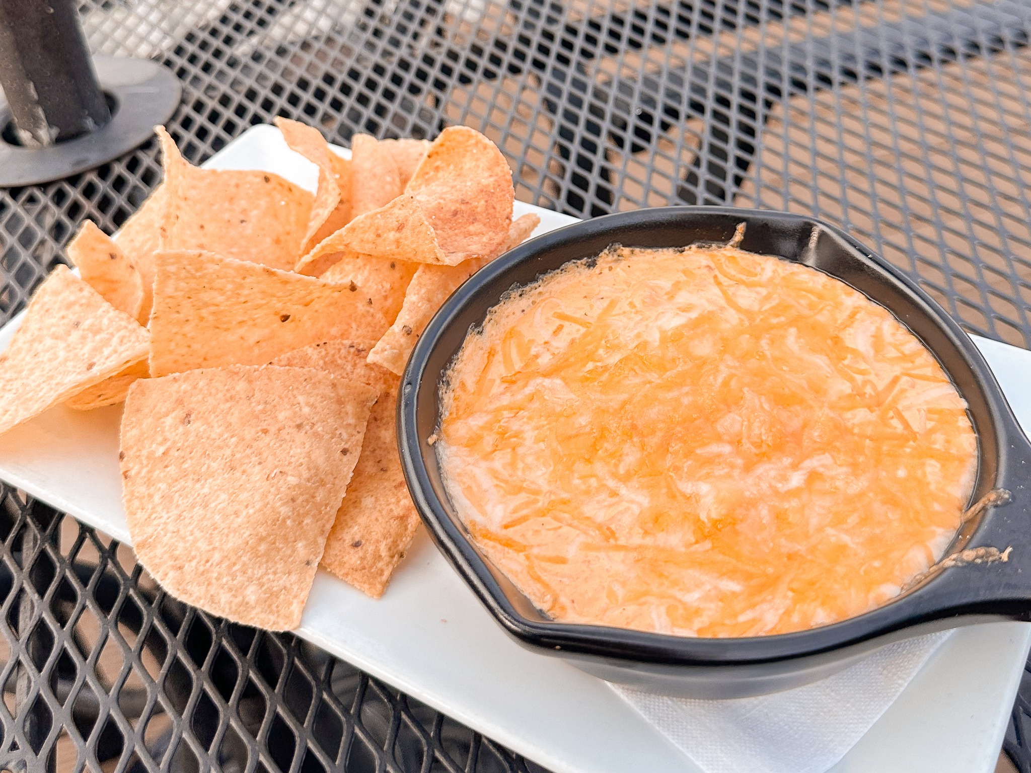 a bowl of crab dip with chips