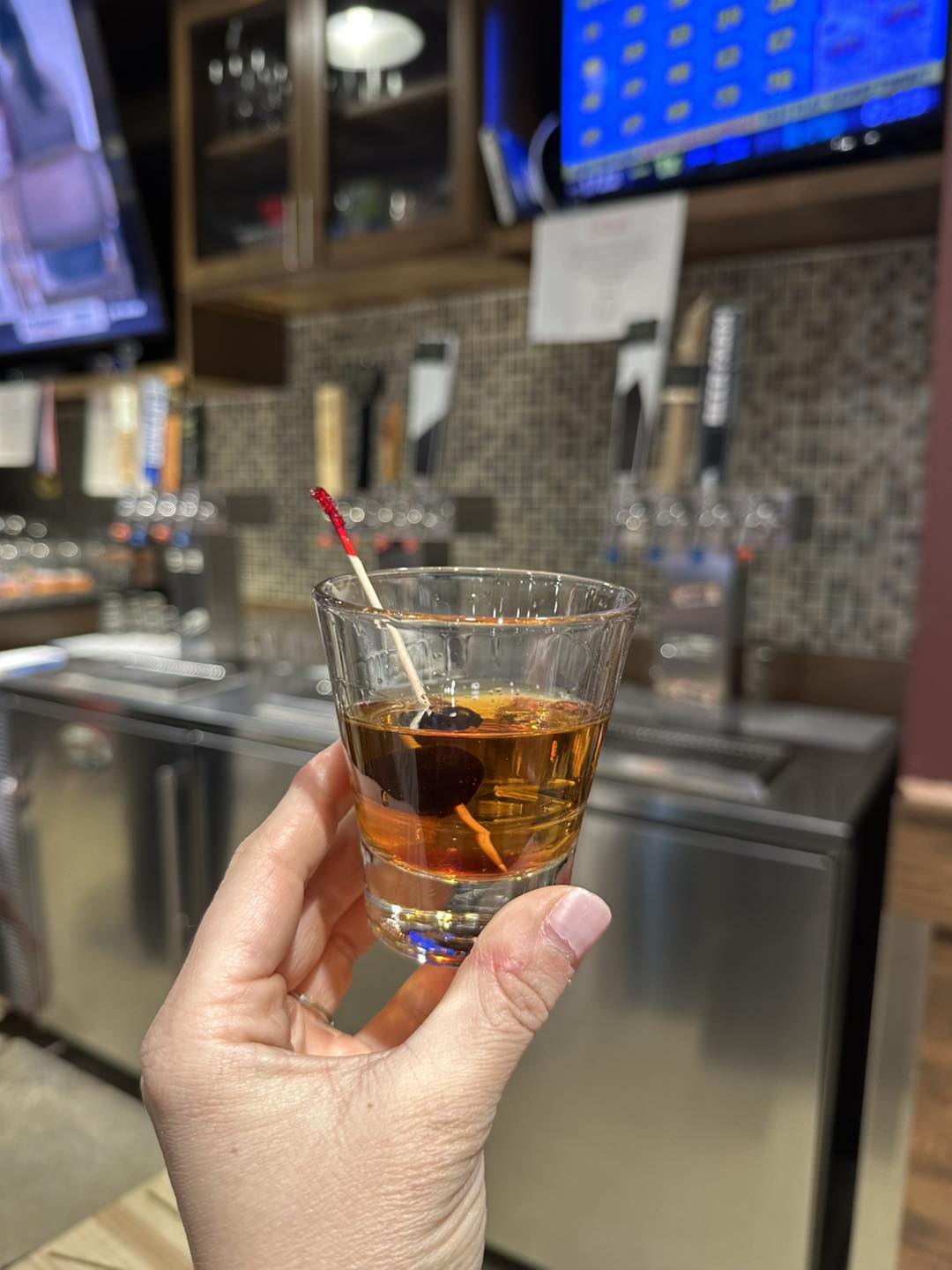 a hand holding a cocktail