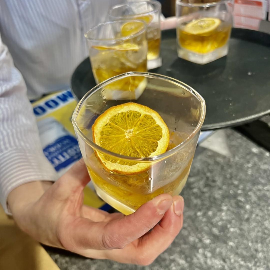 a cocktail with a lemon wheel