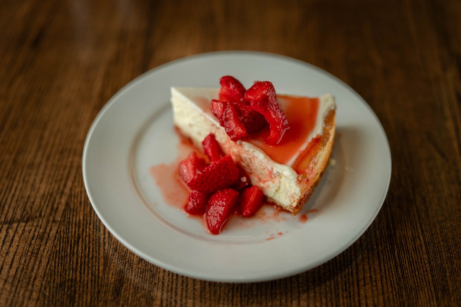 a slice of cheesecake with strawberries