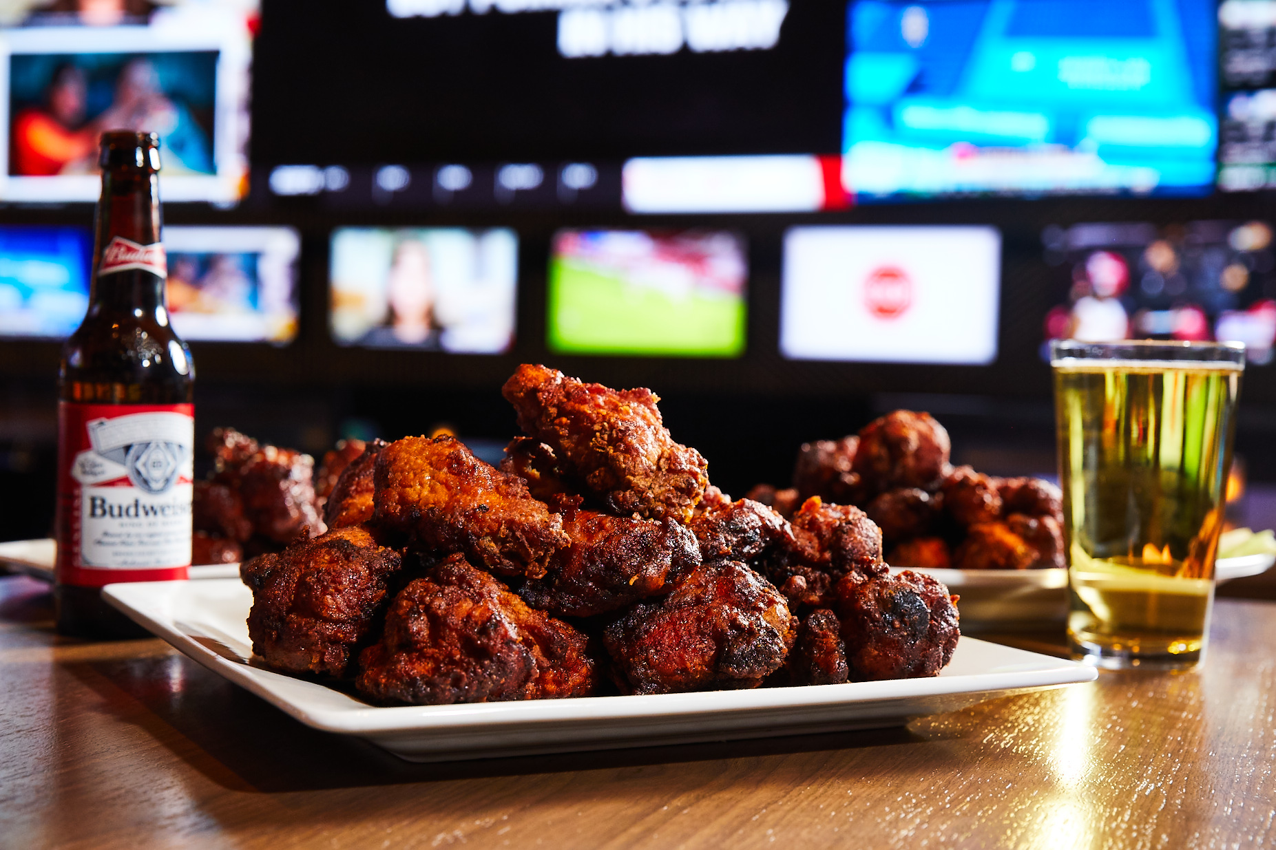a plate of wings with beers