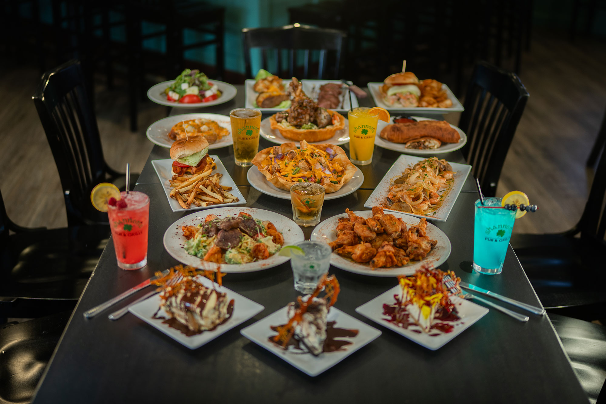 a table with various plates of food and drinks