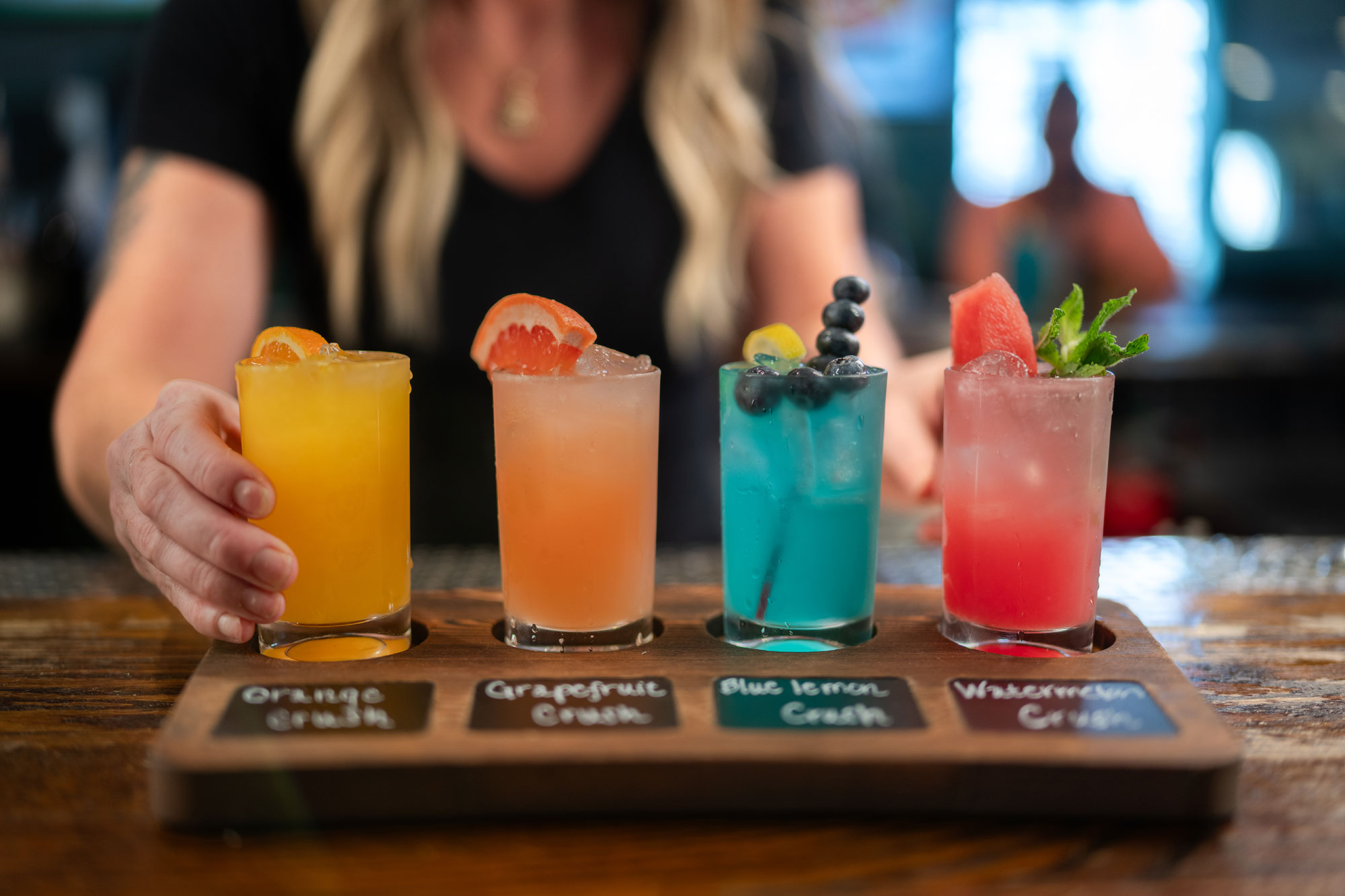a flight of four different colorful cocktails