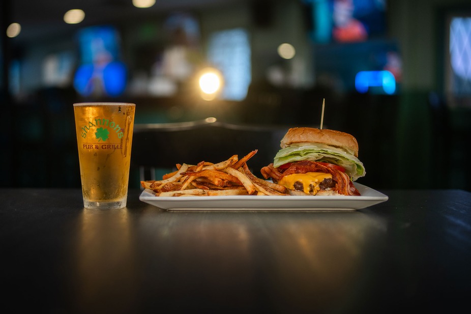 a burger with fries and a beer