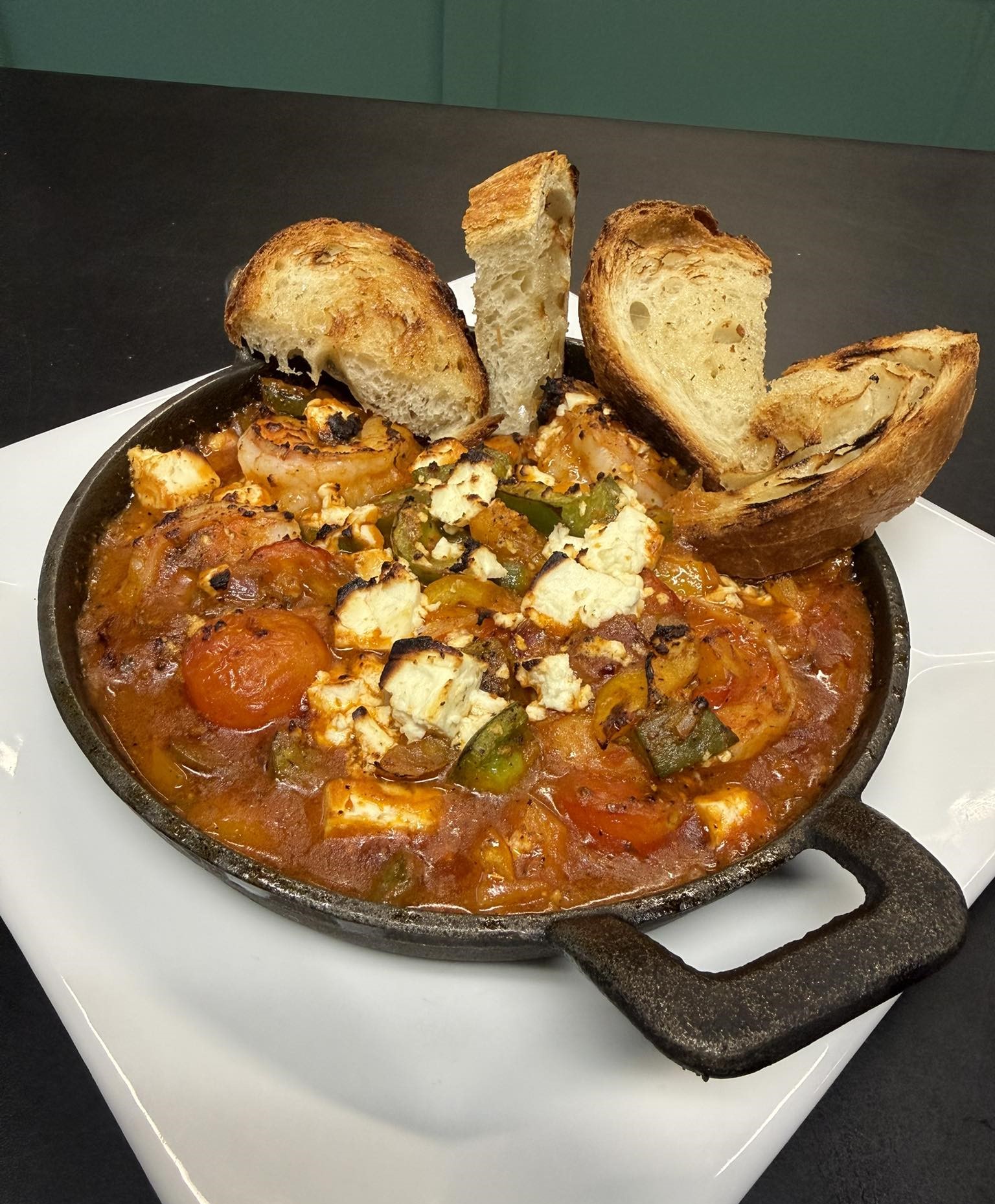 a dish of Shrimp Saganaki with toasted bread