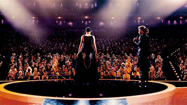 a gif of Katniss Everdeen in her Mockingjay dress opening the wings